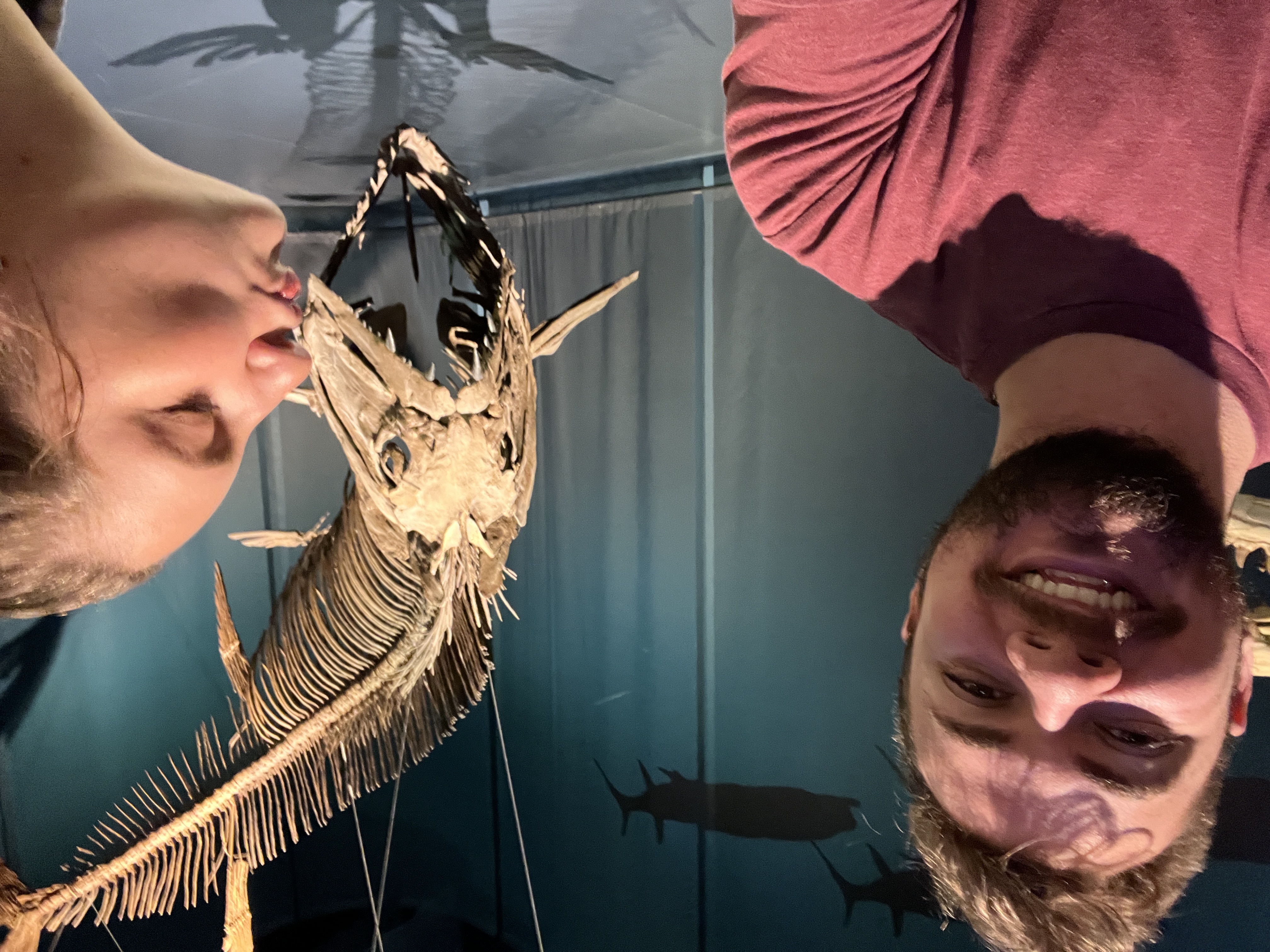 Kat kissing a huge fish fossil